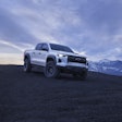 2024 Chevy Colorado ZR2 Bison on hilltop with mountains background grayish blue sky