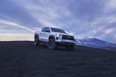 2024 Chevy Colorado ZR2 Bison on hilltop with mountains background grayish blue sky