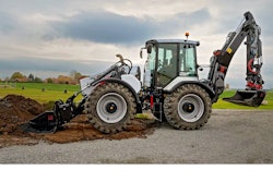 Huddig 1370T hybrid backhoe digging with front loader bucket