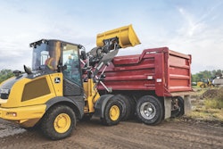 John Deere 244 P-Tier compact wheel loader dumping load.