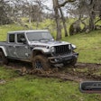 2023 Jeep Gladiator Rubicon FarOut diesel ripping through wooded area in mud
