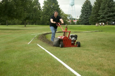 man pushing mini trencher