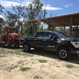2019 Titan XD diesel hitched to trailer carrying tractor