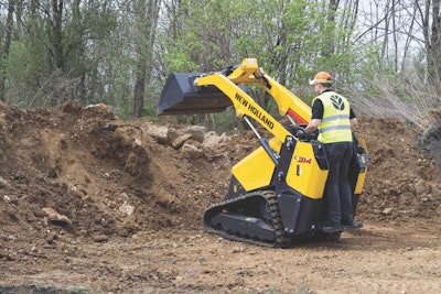 New Holland C314 mini track loader bucket raised over dirt pile