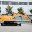 SY135C Sany excavator in parking lot in front of building