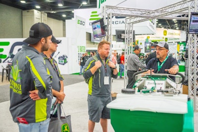 men gathered around trade show booth