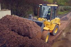 volvo compact wheel loaders filling bucket from dirt pile