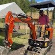 AHM AX-15 mini excavator digs near a house