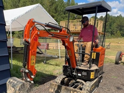 AHM AX-15 mini excavator digs near a house