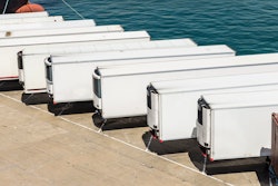 Row of white trailers on pier