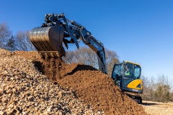 Hyundai HX90A compact excavator dumping dirt
