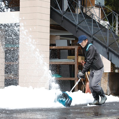 man pushing snow with Makita snow shovel