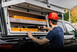 worker orange hard hat pulling toolbox trazer rack on pickup