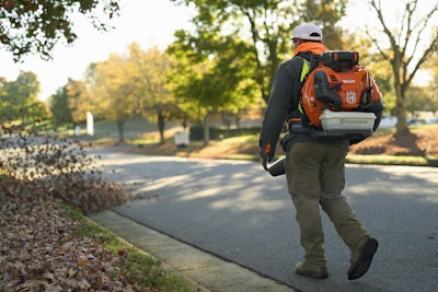 man using Husqvarna backpack blower