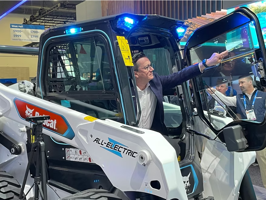 A look at Bobcat's CES booth in 2024, featuring a concept transparent Organic Light Emitting Diode touch display on a S7X electric skid steer loader.