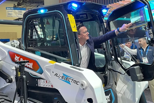 A look at Bobcat's CES booth in 2024, featuring a concept transparent Organic Light Emitting Diode touch display on a S7X electric skid steer loader.