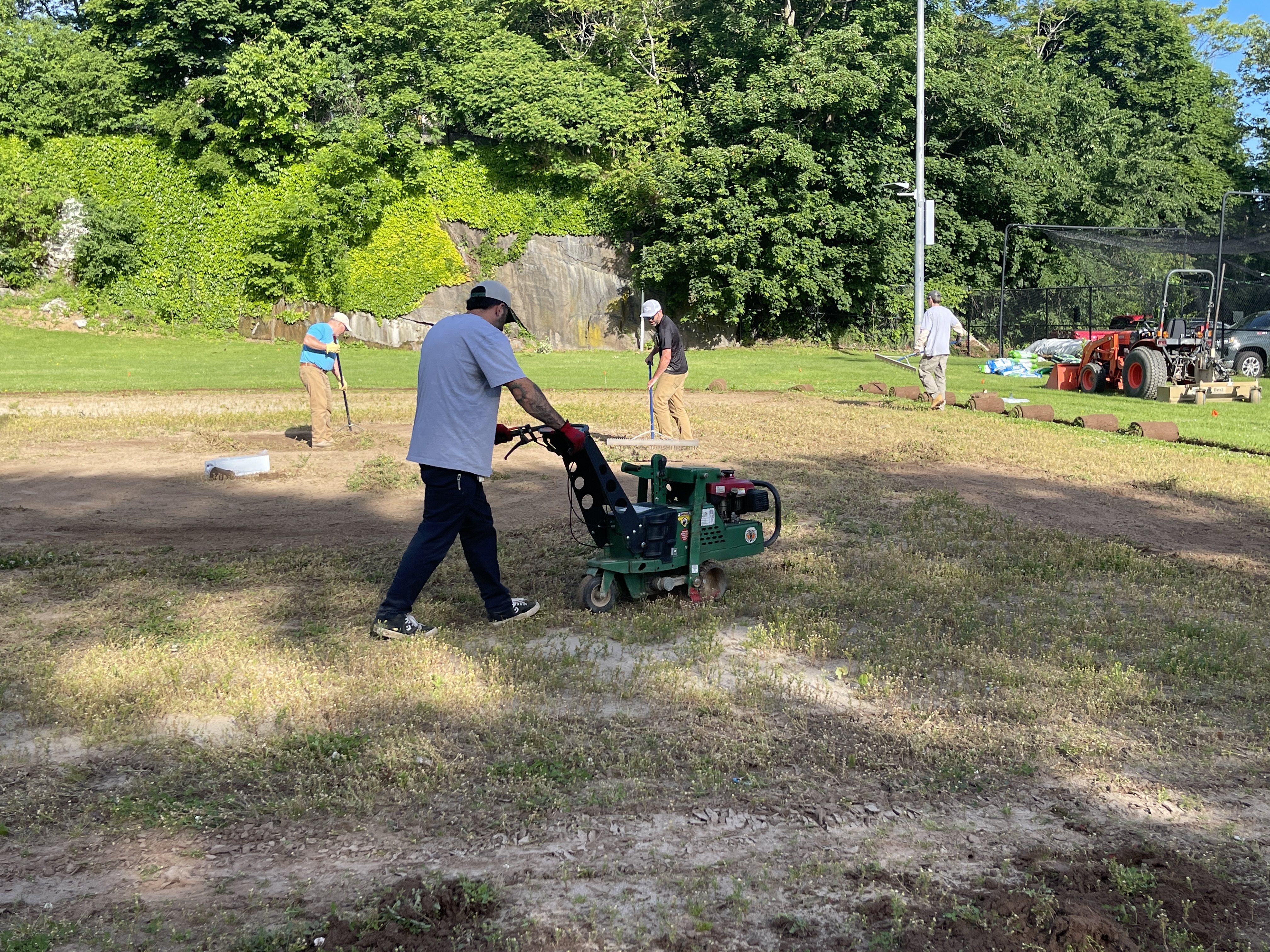 Volunteers from the New England Sports Field Management Association work to restore the baseball field at the Yawkey Boys & Girls Club of Roxbury. Sports field professionals donated their time, expertise, and equipment to transform the aging field as part of Project EverGreen's GreenCare for Communities initiative.