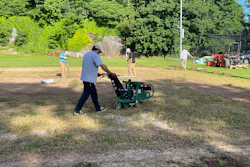 Volunteers from the New England Sports Field Management Association work to restore the baseball field at the Yawkey Boys & Girls Club of Roxbury. Sports field professionals donated their time, expertise, and equipment to transform the aging field as part of Project EverGreen's GreenCare for Communities initiative.