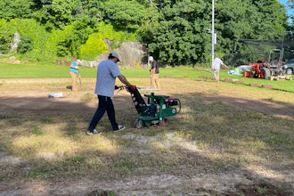 Volunteers from the New England Sports Field Management Association work to restore the baseball field at the Yawkey Boys & Girls Club of Roxbury. Sports field professionals donated their time, expertise, and equipment to transform the aging field as part of Project EverGreen's GreenCare for Communities initiative.
